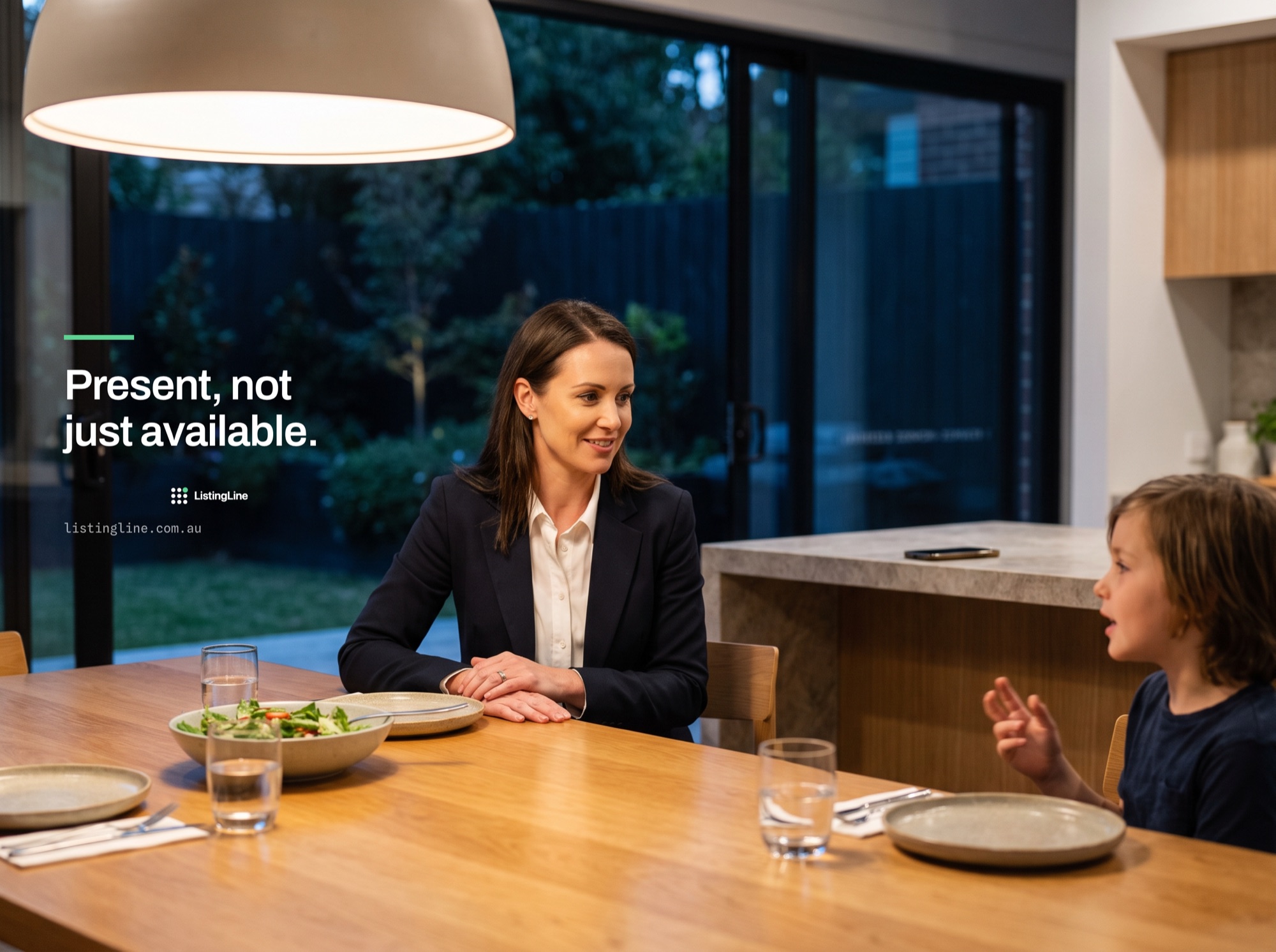 Present, not just available. A real estate agent at the dinner table with her child in the evening, her phone face down on the bench behind her.